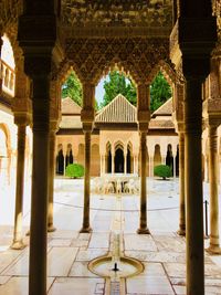 View of a historical building. view through the pillars of la alhambra, palace in spain.