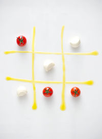 Tomatoes and cheese on tic-tac-toe grid