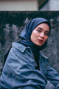 Portrait of beautiful young woman standing outdoors