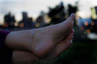 Low section of woman on grassy field