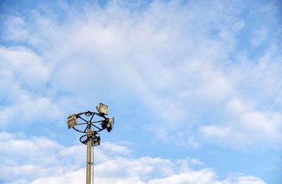 Low angle view of street light against cloudy sky