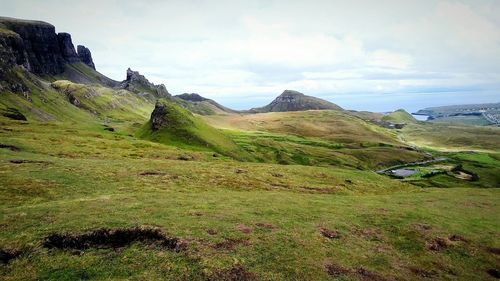 Scenic view of mountains against cloudy sky