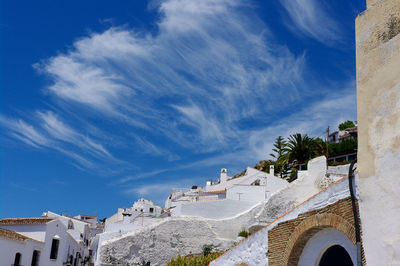 Low angle view of buildings against blue sky