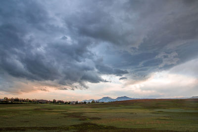 Scenic view of field against sky during sunset