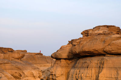 Low angle view of rock formations against sky