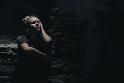 Portrait of depressed woman in basement