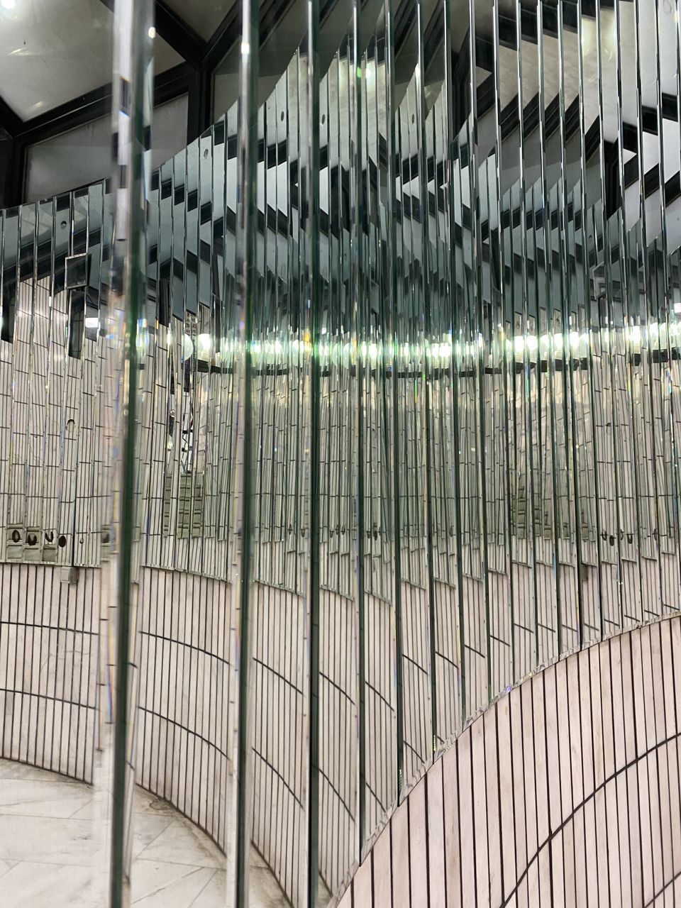 CLOSE-UP OF METAL FENCE BY ILLUMINATED LIGHTS