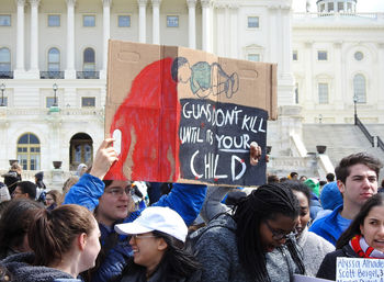 Group of people against buildings in city