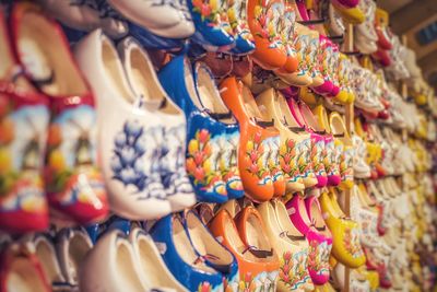 Traditional dutch clogs in rows on a wall in a shop