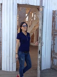 Woman looking away while standing at doorway