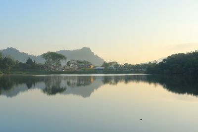 Scenic view of lake against clear sky during sunset
