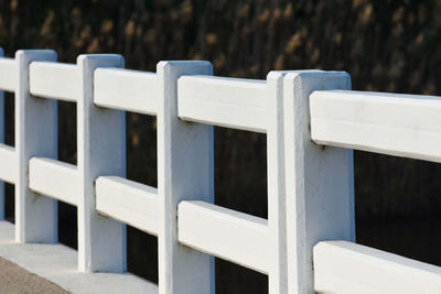 Close-up of white wooden bench