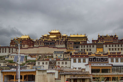 Buildings in city against sky