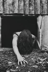 Woman with messy hair picking from window