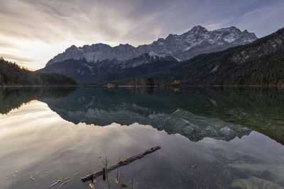 Scenic view of lake by mountains against sky