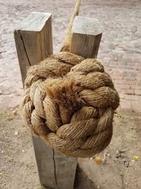 Close-up of rope tied up on wooden post