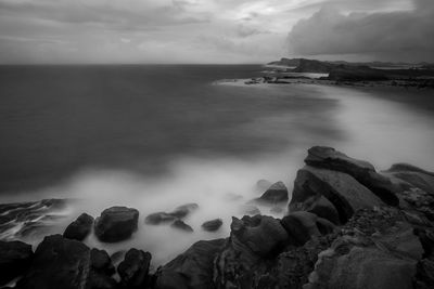 Scenic view of sea against cloudy sky