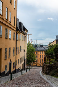 Street amidst buildings in town against sky