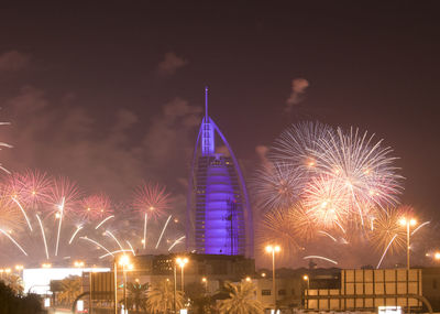 Firework display in city at night