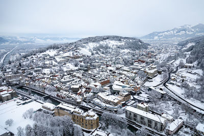 High angle view of snow covered houses against sky