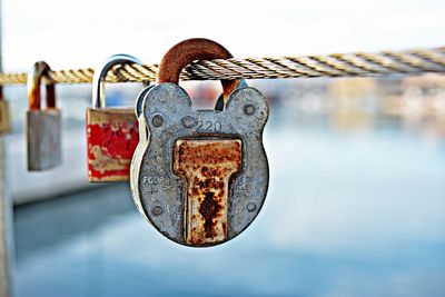 Close-up of padlocks hanging on rope