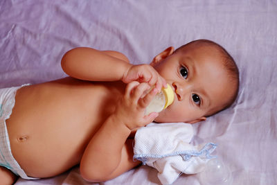 Portrait of cute baby boy sleeping on bed at home