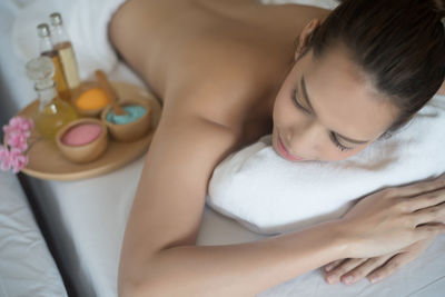 Young woman lying on massage table