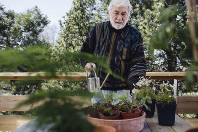 Portrait of man standing against plants