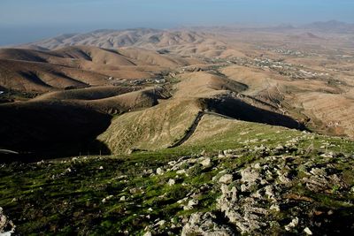 High angle view of land and mountains against sky