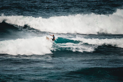 Man surfing waves in atlantic ocean, tenerife, spain