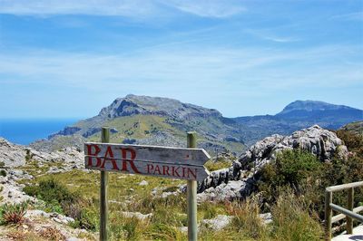 View of signboard against mountain range