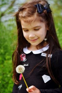 Close-up of cute girl holding flowers