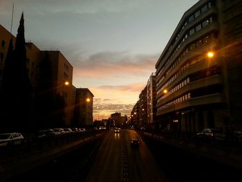 Road passing through city at night