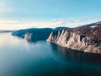 Panoramic view of sea and mountains against sky