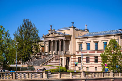 Low angle view of building against clear blue sky