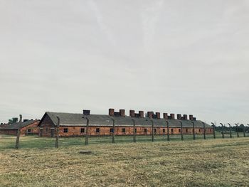 Abandoned built structure on field against sky