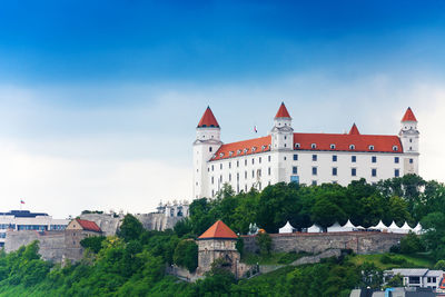 Buildings in city against blue sky