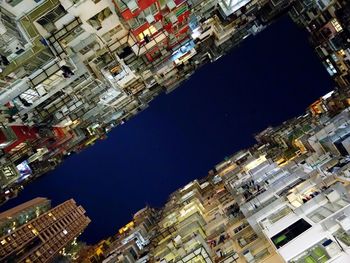 Low angle view of cityscape against clear sky at night