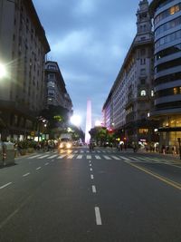 City street and buildings against sky