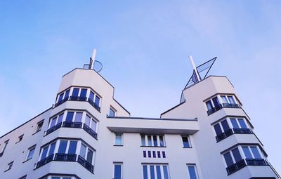 Low angle view of residential building against blue sky