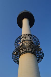 Low angle view of water tower against clear blue sky