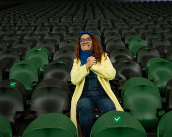 Portrait of young woman sitting in gym