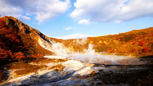 Scenic view of waterfall against sky