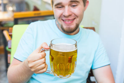 Portrait of a young man drinking glass