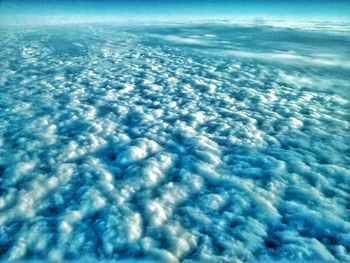 Aerial view of frozen sea against blue sky