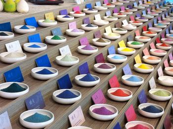 High angle view of multi colored powder paints for sale in market