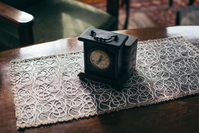 Close-up high angle view of clock on table