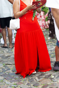 Catholic and candomble people are seen dressed in red clothes during a party 