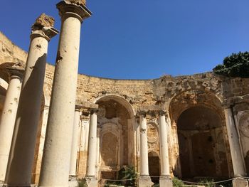 Low angle view of historical building against blue sky