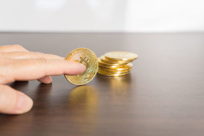 Close-up of hand holding coins